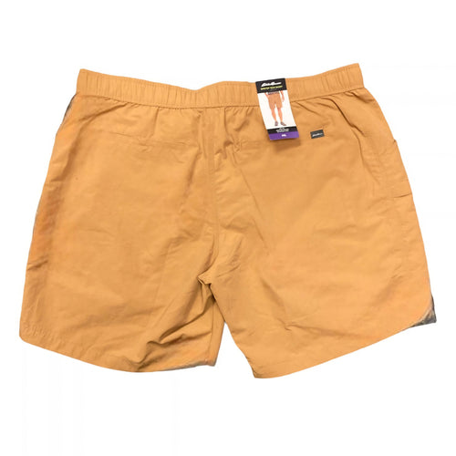 A pair of men's casual shorts in a warm mustard yellow color, shown flat against a white background with a retail hangtag attached at the waistband.