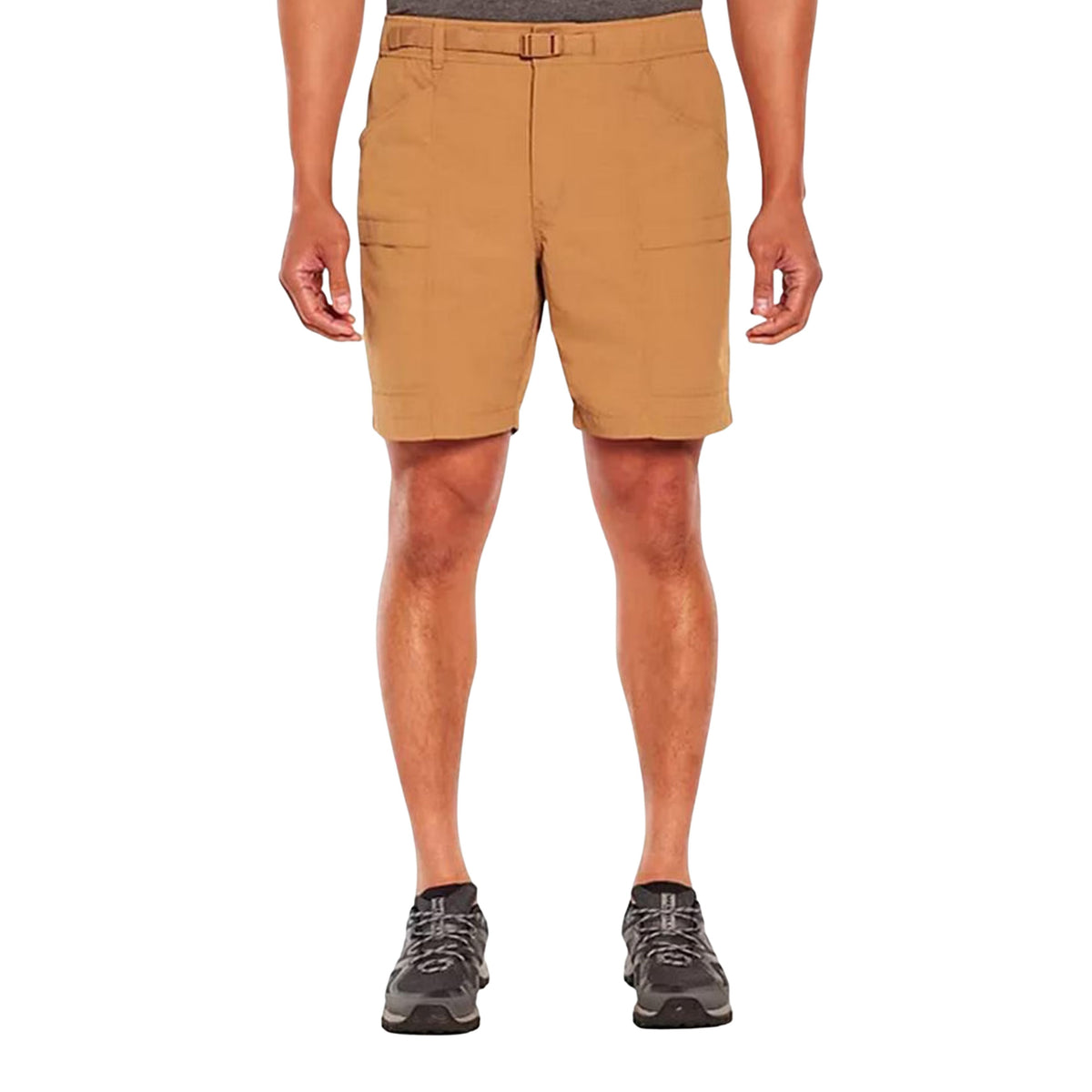 A person wearing tan utility shorts with side pockets, shown from the waist down against a plain white background.