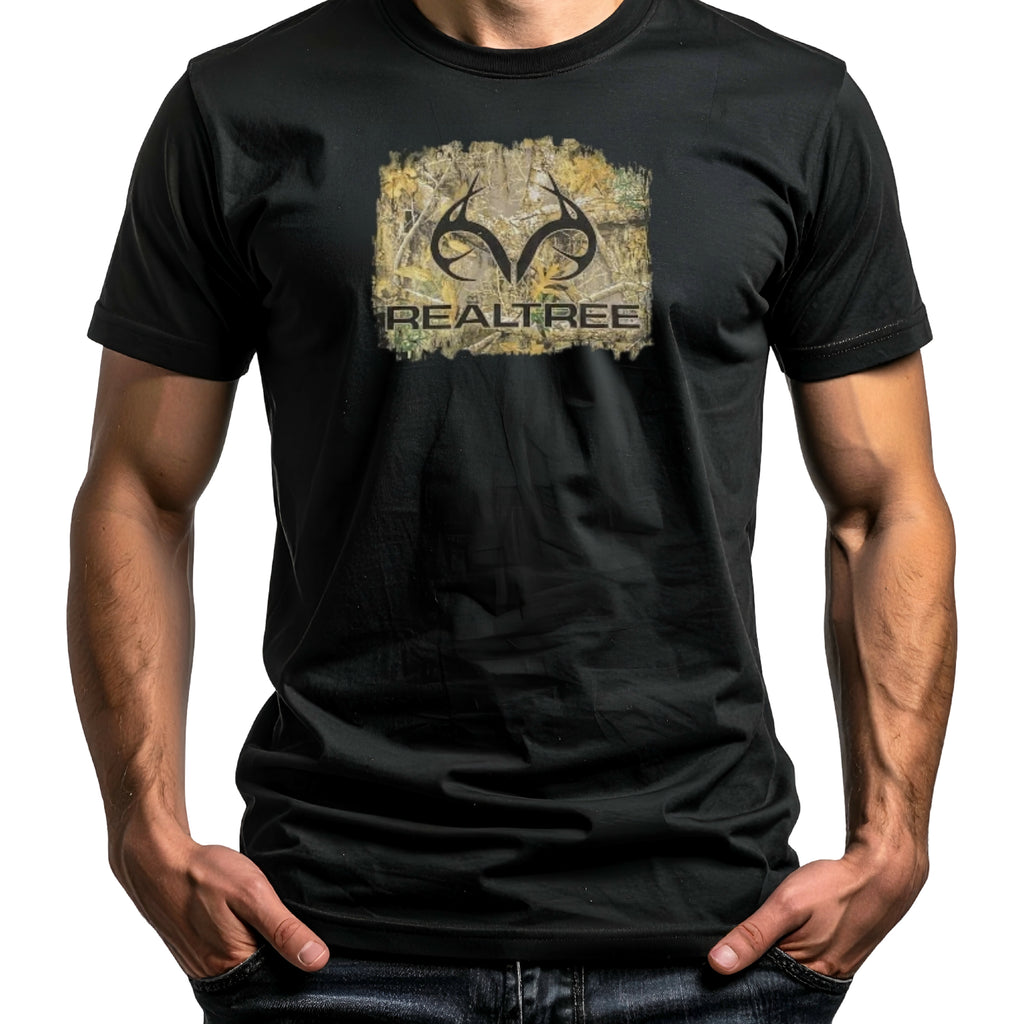 A man wearing a black short-sleeve t-shirt with a distressed Realtree logo graphic on the chest, set against a plain white background.