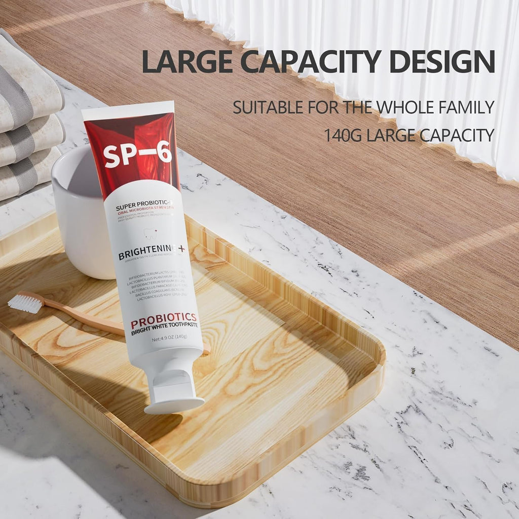 SP-6 Probiotic Whitening Toothpaste 140g tube displayed on a wooden bathroom tray