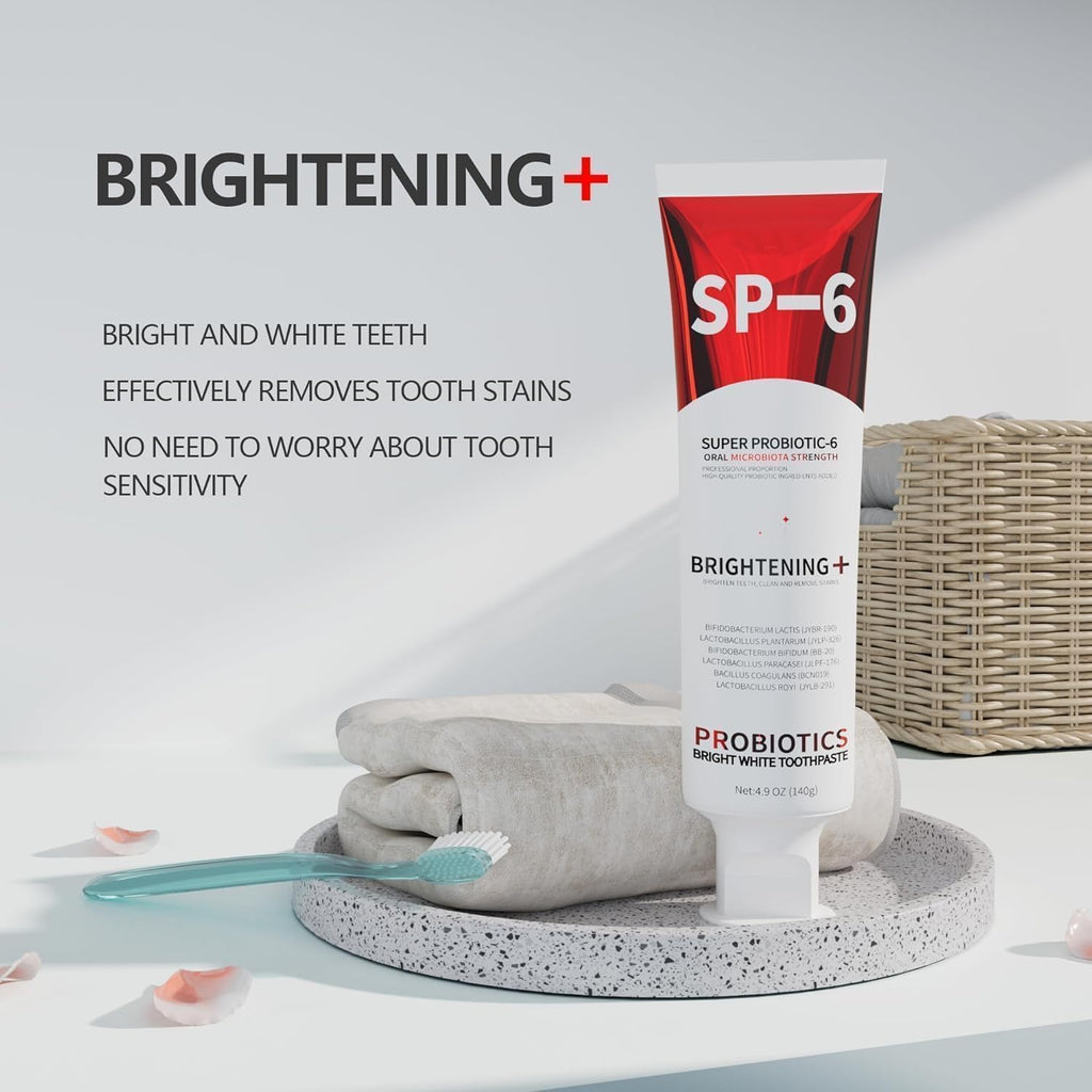 SP-6 Probiotic Toothpaste tube next to rolled towels highlighting brightening and stain removal