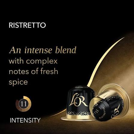 Ristretto coffee capsules on a black background with gold lighting and text describing the intense spice blend.